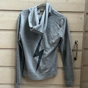 Hoodie is worn and has rips near pocket.